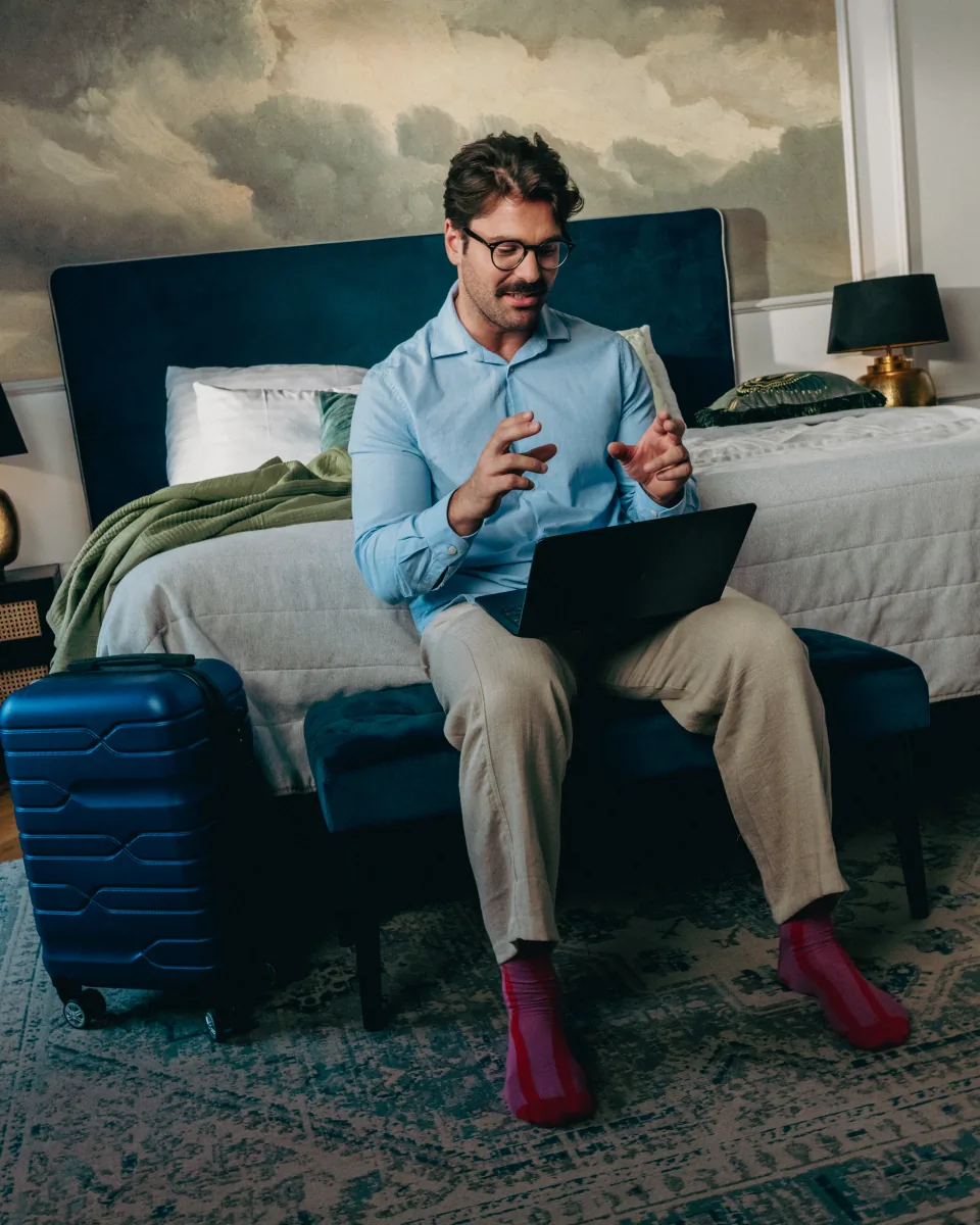 Solo traveler working on a laptop in a bright apartment